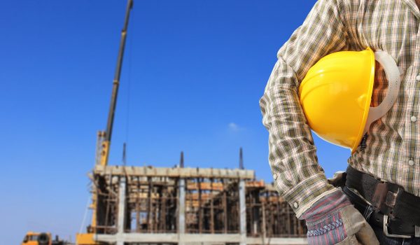 17511198 - worker and the blurred construction against blue sky